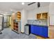 Kitchen area featuring a mini fridge, blue cabinets, and tile flooring at 1878 Suwanee Roberts Ct, Lawrenceville, GA 30043