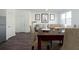 Dining room with dark floors that flows into a living area with natural light at 2544 Coventry Street Sw, Atlanta, GA 30331