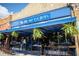 Charming storefront with outdoor seating under blue awning, adorned with hanging plants at 2544 Coventry Street Sw, Atlanta, GA 30331