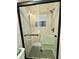 Updated bathroom featuring hexagon tile flooring, glass shower, and modern hardware at 6501 Menlo Way, Rex, GA 30273
