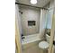 Bathroom features updated vanity with modern fixtures, built-in shelves, and a shower-tub combination at 6501 Menlo Way, Rex, GA 30273