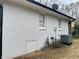 Painted brick exterior with white-trimmed windows and an access door to the basement at 6501 Menlo Way, Rex, GA 30273