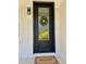 Elegant front door with decorative glass, complemented by a welcome mat and painted brick surround at 6501 Menlo Way, Rex, GA 30273