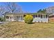 Charming single-story home with a white brick facade and well-maintained lawn at 6501 Menlo Way, Rex, GA 30273