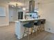Kitchen island with bar stool seating and pendant lights with stainless steel appliances and modern cabinets at 6501 Menlo Way, Rex, GA 30273