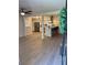 Open concept living room and kitchen with hardwood floors, stainless steel appliances, and natural light at 6501 Menlo Way, Rex, GA 30273