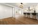 Open-concept living area with modern finishes features a breakfast bar and wood-look flooring at 6501 Menlo Way, Rex, GA 30273