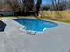 A refreshing inground pool surrounded by a concrete deck and grassy area at 6501 Menlo Way, Rex, GA 30273