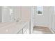 Bright bathroom featuring a white vanity with a quartz countertop and a glass-enclosed shower at 1032 Sutherland Lane (Lot 47), Lawrenceville, GA 30043