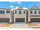 Charming townhome featuring a tandem garage, modern architecture, and beautiful curb appeal at 1032 Sutherland Lane (Lot 47), Lawrenceville, GA 30043