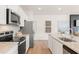 Kitchen featuring stainless steel appliances, white cabinets and island at 1032 Sutherland Lane (Lot 47), Lawrenceville, GA 30043