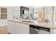 Kitchen island featuring granite countertops and stainless steel dishwasher at 1032 Sutherland Lane (Lot 47), Lawrenceville, GA 30043