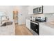 Kitchen with stainless steel appliances, white cabinets and pantry at 1032 Sutherland Lane (Lot 47), Lawrenceville, GA 30043