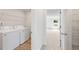 Convenient laundry room with washer, dryer, and shelving for ample storage at 1032 Sutherland Lane (Lot 47), Lawrenceville, GA 30043