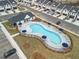 Aerial view of pool featuring lounge area, set between residential parking and units at 1032 Sutherland Lane (Lot 47), Lawrenceville, GA 30043