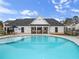 Community pool view from pool, featuring chairs and covered area with tables and chairs at 1032 Sutherland Lane (Lot 47), Lawrenceville, GA 30043