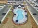 Drone image of the community pool offering shaded seating, surrounded by residential parking and units at 1032 Sutherland Lane (Lot 47), Lawrenceville, GA 30043