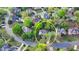 Aerial view of a home nestled in a neighborhood with mature trees and well-manicured lawns at 10355 Oxford Mill Cir, Johns Creek, GA 30022