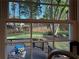 Beautiful backyard view featuring a wooden deck, green lawn, and mature trees at 10355 Oxford Mill Cir, Johns Creek, GA 30022
