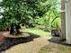 Serene backyard with lush green lawn, mature trees, and a cozy seating area, creating a peaceful retreat at 10355 Oxford Mill Cir, Johns Creek, GA 30022