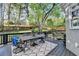 Spacious outdoor deck with metal table set, chairs and a decorative rug, perfect for entertaining with great backyard views at 10355 Oxford Mill Cir, Johns Creek, GA 30022