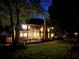 Wide backyard view of the home showing the deck, expansive lawn, and mature trees enhancing its curb appeal and outdoor living space at 10355 Oxford Mill Cir, Johns Creek, GA 30022