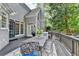 Outdoor deck with metal table set with chairs, perfect for entertaining with backyard views and grilling area at 10355 Oxford Mill Cir, Johns Creek, GA 30022