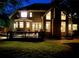 The backyard features a wooden deck, well-maintained lawn, and views of the home's rear facade, highlighting its architectural features at 10355 Oxford Mill Cir, Johns Creek, GA 30022