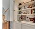 Convenient bar area with shelving, sink, and stylish decor for entertaining at 10355 Oxford Mill Cir, Johns Creek, GA 30022