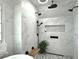 This bathroom features a rainfall shower behind a marble wall and a built-in bench at 10355 Oxford Mill Cir, Johns Creek, GA 30022
