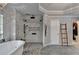 This bathroom features a standalone tub and a rainfall shower behind a marble wall at 10355 Oxford Mill Cir, Johns Creek, GA 30022
