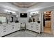This luxurious bathroom features and vanities, a large mirror, and modern fixtures at 10355 Oxford Mill Cir, Johns Creek, GA 30022