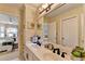 Bathroom with double vanity, framed mirrors, recessed lighting, and lots of counter space at 10355 Oxford Mill Cir, Johns Creek, GA 30022