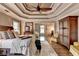 Spacious bedroom with tray ceiling, sitting room, and hardwood floors at 10355 Oxford Mill Cir, Johns Creek, GA 30022