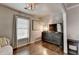 This bedroom features hardwood floors, large window, and dark wood dresser at 10355 Oxford Mill Cir, Johns Creek, GA 30022