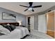 Comfortable bedroom featuring a ceiling fan, closet, and a serene gray and white color palette at 10355 Oxford Mill Cir, Johns Creek, GA 30022