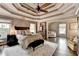 Large bedroom with tray ceilings, hardwood floors and a sitting room at 10355 Oxford Mill Cir, Johns Creek, GA 30022