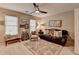 Comfortable bedroom featuring neutral colors, a ceiling fan, and leather couch for a relaxing space at 10355 Oxford Mill Cir, Johns Creek, GA 30022