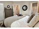Calm bedroom with dresser and view into ensuite bathroom at 10355 Oxford Mill Cir, Johns Creek, GA 30022