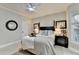 Relaxing bedroom with ample natural light, ceiling fan, and cozy carpet at 10355 Oxford Mill Cir, Johns Creek, GA 30022