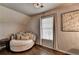 This bedroom features hardwood floors and a comfortable rounded couch with multiple pillows at 10355 Oxford Mill Cir, Johns Creek, GA 30022