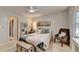 Bright bedroom featuring neutral colors, a ceiling fan, and chair for relaxing in comfort at 10355 Oxford Mill Cir, Johns Creek, GA 30022