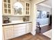 Butler's pantry featuring white cabinetry, hardwood floors, and view into a hallway at 10355 Oxford Mill Cir, Johns Creek, GA 30022