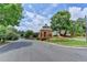 Welcoming neighborhood entrance with a gazebo, lush landscaping, and an American flag at 10355 Oxford Mill Cir, Johns Creek, GA 30022