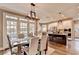 Bright dining area with large windows and an open concept kitchen, perfect for entertaining at 10355 Oxford Mill Cir, Johns Creek, GA 30022