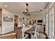 Formal dining room features a modern chandelier, seating for six, and access to outdoor living at 10355 Oxford Mill Cir, Johns Creek, GA 30022