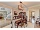Dining room with a wood table, hardwood floors, moldings, and light fixture at 10355 Oxford Mill Cir, Johns Creek, GA 30022