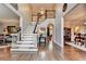 Elegant foyer with hardwood floors, a grand staircase, and sophisticated decor at 10355 Oxford Mill Cir, Johns Creek, GA 30022