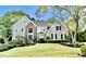 Charming two-story home with stone accents and landscaped front yard, lush green lawn at 10355 Oxford Mill Cir, Johns Creek, GA 30022