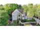 Traditional two-story home with stone accents, manicured landscaping, and a welcoming front entrance at 10355 Oxford Mill Cir, Johns Creek, GA 30022